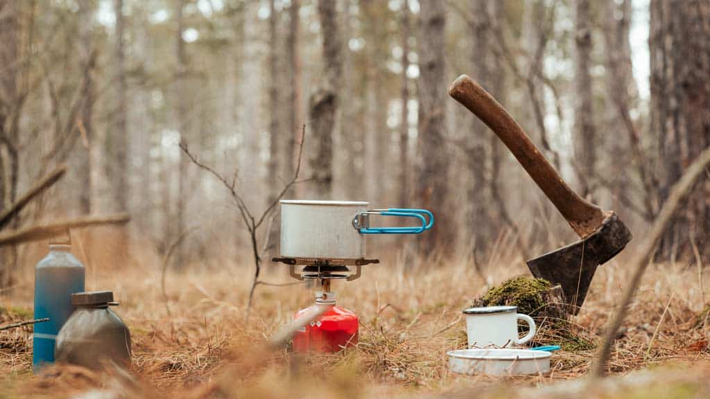 Waldbild mit Gaskocher und Axt